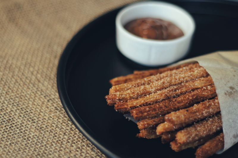 Golden churro bites with dipping sauce